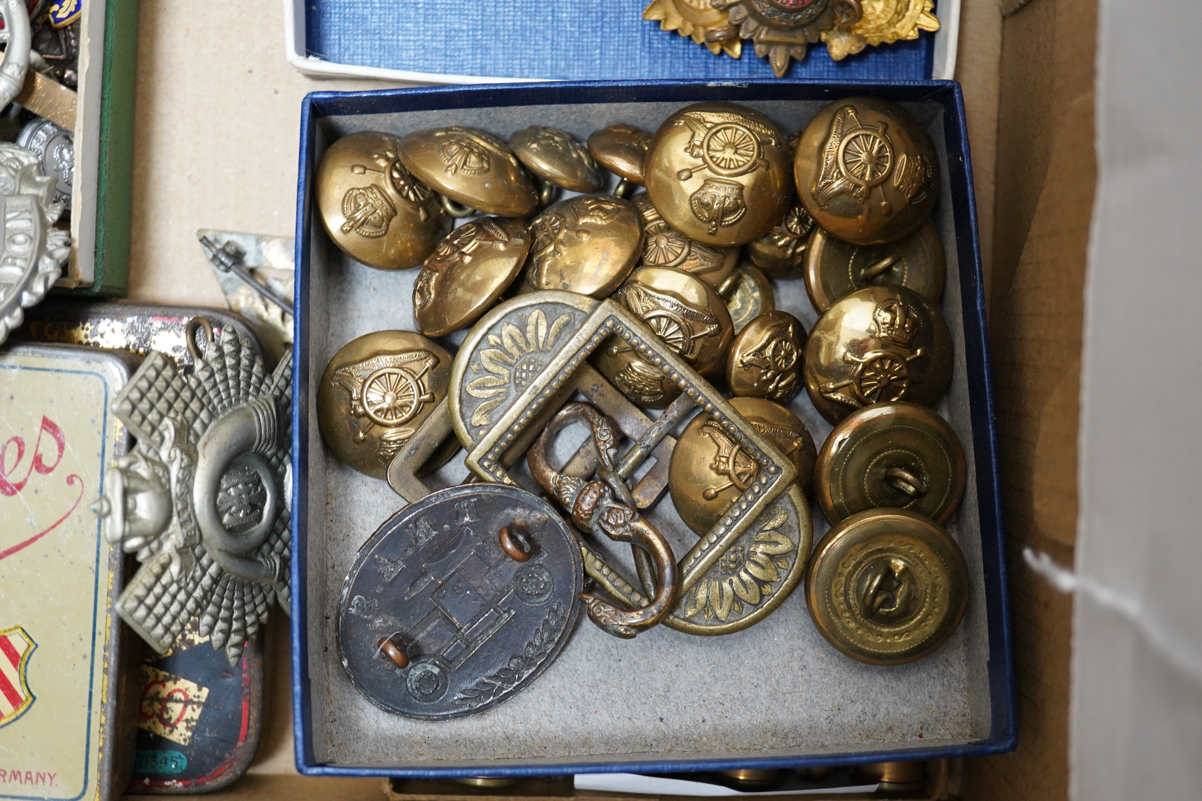 A collection of military medals, cap badges and buttons etc. including; a First World War Royal Navy Air Service cap badge, two WWI medal trios awarded to PTE. V.J.P. Barnes RIF. BRIG., and L.Cpl. W. Howard. NOTTS & DERB